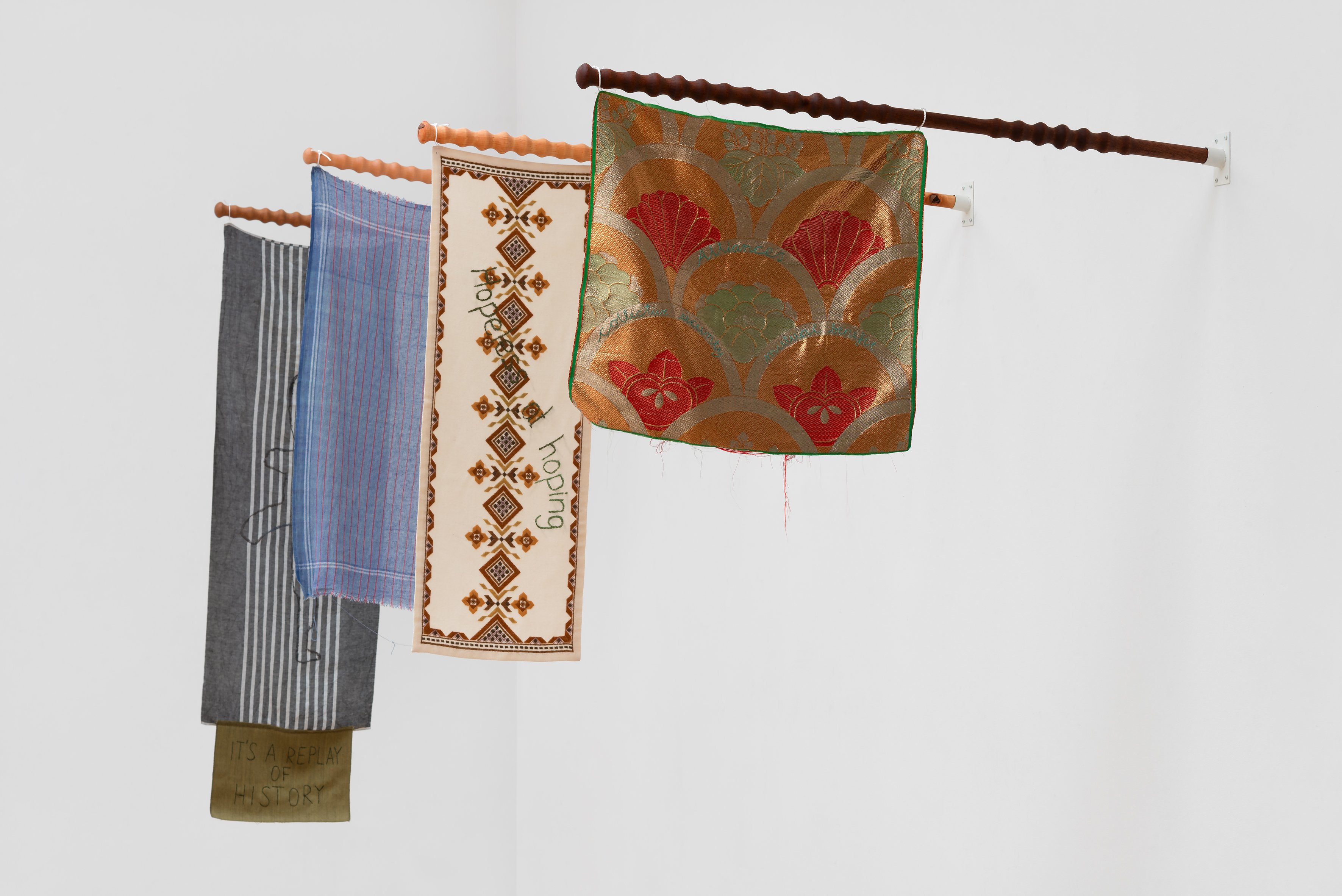 Alle flagene er syet sammen af brugte tekstiler, Hesselholdt & Mejlvang har indsamlet fra hele verden. Flere af dem er med broderede tekster. Foto: Jacob Friis-Holm Nielsen